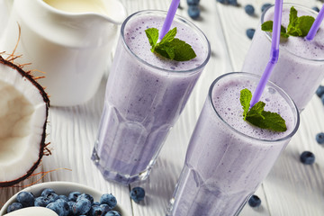 close-up of blueberry frothy milkshake, top view