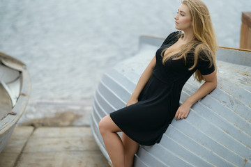 Young woman sitting down on the boat.
