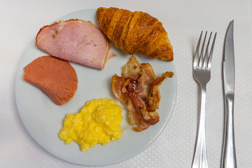 Breakfast meal with ham croissant and scrambled egg