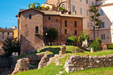 Fototapeta na wymiar View of many stones, ruins and coay brown house in old town of Rome