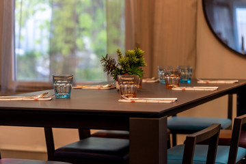 Well-decorated table and glasses prepared for home dining