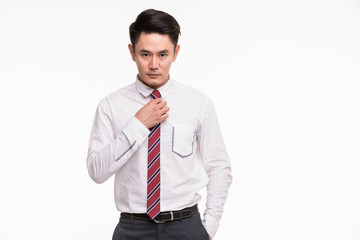 Businessman standing and touchs his tie.