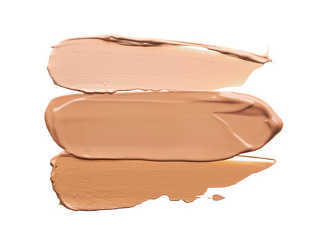 Gently beige strokes and texture of face highlighter or acrylic paint isolated on white background