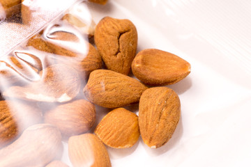 almonds packages in plastic packaging on white
