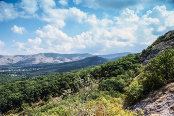 Fototapeta na wymiar The mountains with a cloud overhead.Landscape of mountains and rocks. Shadow stone mountain of forest. Green nature of stone mountain