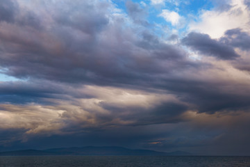 Fototapeta premium storm clouds over the sea during sunset