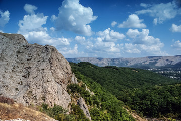  The mountains  with a cloud overhead.Landscape of mountains and rocks. Shadow stone mountain of forest. Green nature of stone mountain