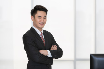 Businessman standing and crossed his arm..