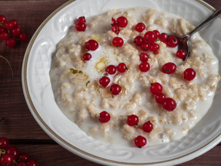 Healthy Breakfast of oatmeal with fresh fruit in a white plate
