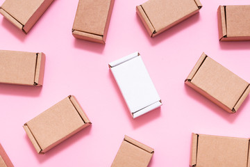Lot of small cardboard boxes on pink background
