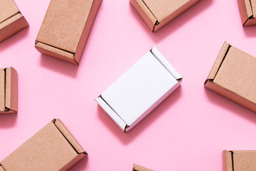Lot of small cardboard boxes on pink background