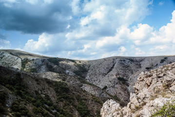  The mountains  with a cloud overhead.Landscape of mountains and rocks. Shadow stone mountain of forest. Green nature of stone mountain