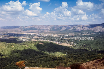  The mountains  with a cloud overhead.Landscape of mountains and rocks. Shadow stone mountain of forest. Green nature of stone mountain