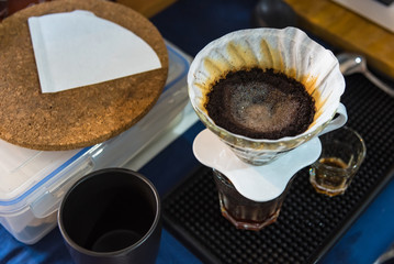 Close up of filter coffee maker, kettle with thermometer and digital scale on wooden table.Barista brewing coffee, method pour over, drip coffee.