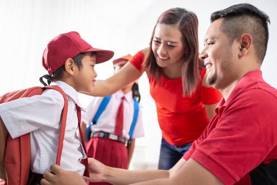 parent help their children getting ready for school. back to school student with uniform