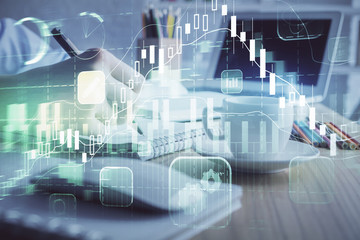 Financial chart drawn over hands taking notes background. Concept of research. Double exposure