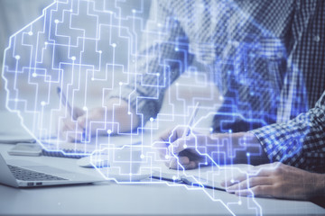 Man typing on keyboard background with brain hologram. Concept of big Data.