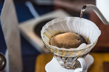 Close up of filter coffee maker, kettle with thermometer and digital scale on wooden table.Barista brewing coffee, method pour over, drip coffee.