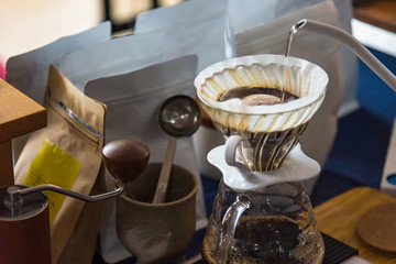 Close up of filter coffee maker, kettle with thermometer and digital scale on wooden table.Barista...