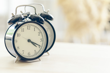 Morning sun. Alarm clock on a beautiful background