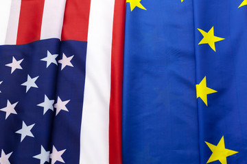 Closeup of Flags of USA and European Union lying together on table