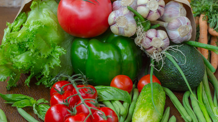 Healthy food in full paper bag of different products, vegetables. Top view. Food background.