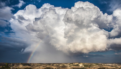 Fototapeta na wymiar Awesome Cumulonimbus cloud with rainbow in Larnaca, Cyprus