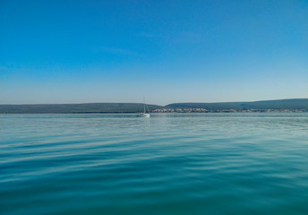 Wonderful calm blue adriatic sea shot from moving sailing boat.
