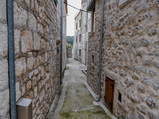 Old fishing village narrow streets between stone build houses.