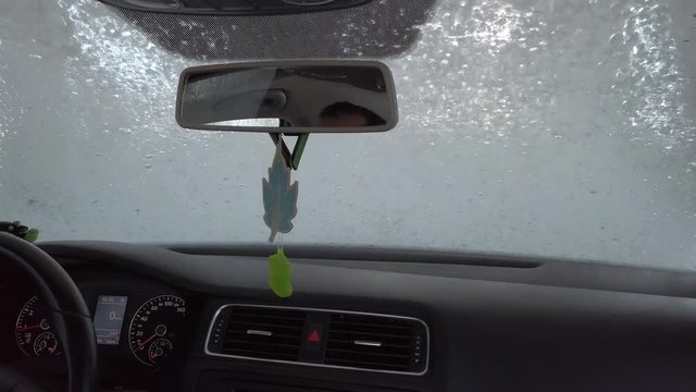 Car on an automatic car wash, shooting from the inside