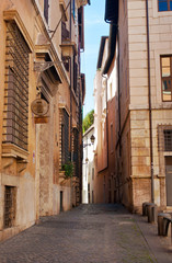 Fototapeta premium Narrow solitary street in the city center of Rome