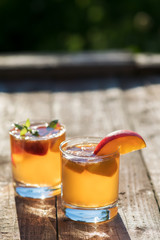 Homemade Fermented Raw Kombucha Tea Ready to Drink With peach. Summer probiotic healthy beverage in glass.