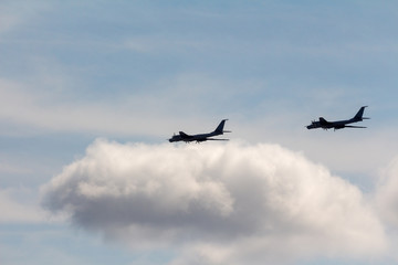 Black silhouettes flying Russian Tu-95 strategic bombers against the sky (NATO reporting name: 