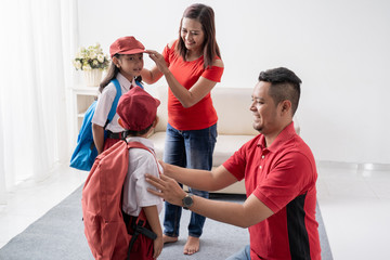 Fototapeta premium parent help their children getting ready for school. back to school student with uniform
