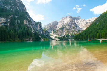 Turquoise water of the lake Lago di Braies, Pragser Wildsee surrounded by pine forest and mountains in the Prags Dolomites in South Tyrol, Italy, Europe