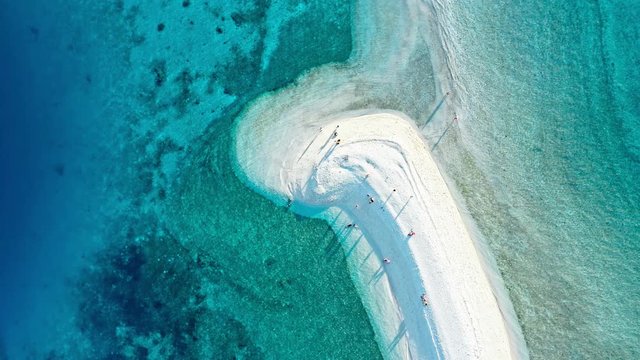 Top down view of tropical sandbar beach with turquoise water and white sand