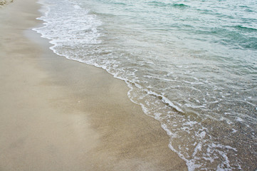 Sea wave on the clean sandy shore of the Black Sea