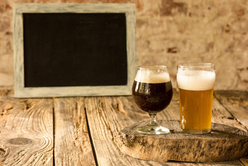 Glasses of different kinds of dark and light beer on wooden table in line. Cold delicious drinks prepared for a big friend's party. Concept of drinks, fun, meeting, oktoberfest. Copyspace.