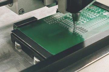 Automated manufacturing process for boards or microchips for electronics or computers.