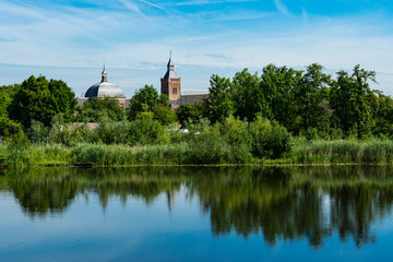 River Linge with reflection and church of Leerdam. The Netherlands