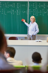 Math teacher in class with chalkboard