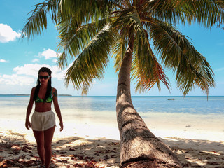 woman walking around into the palm tree jungle in Onok island in  Balabac in Philippines