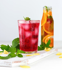 summer refreshing drink with berries of cranberries and pieces of ice in a glass