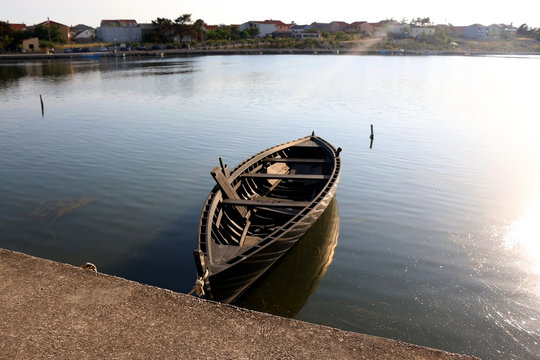 Traditional historic wooden boat called Condura Croatica, in port of Nin, Croatia. - Powered by Adobe