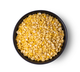 peeled split mung beans in a bowl isolated on white background. top view