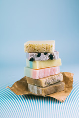 colorful handmade soaps on blue background © cherryandbees