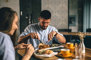 A happy young couple having dinner at a fancy restaurant