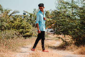 Fototapeta na wymiar Indian male model posing for the photo while walking in the farm
