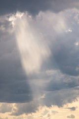 Vivid sunbeam light ray from clouds