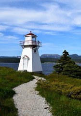 closeup of the red and white lighthouse in Woody Point, Gros Morne National Park Newfoundland and...